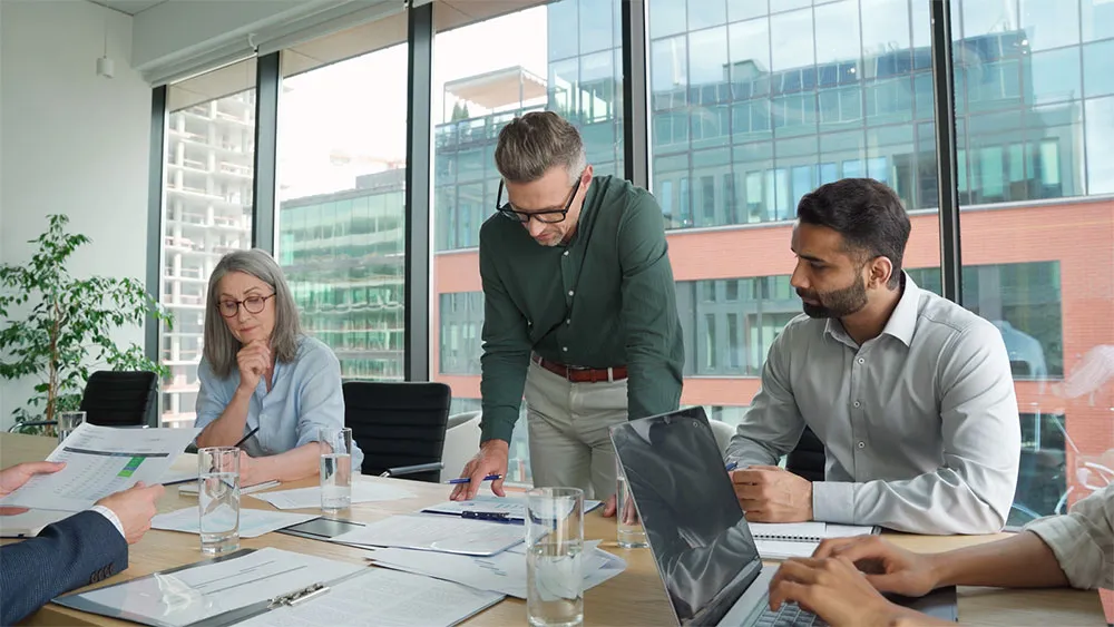 Business team reviewing financial documents during a meeting, discussing corporate accounting services and financial planning in Dubai