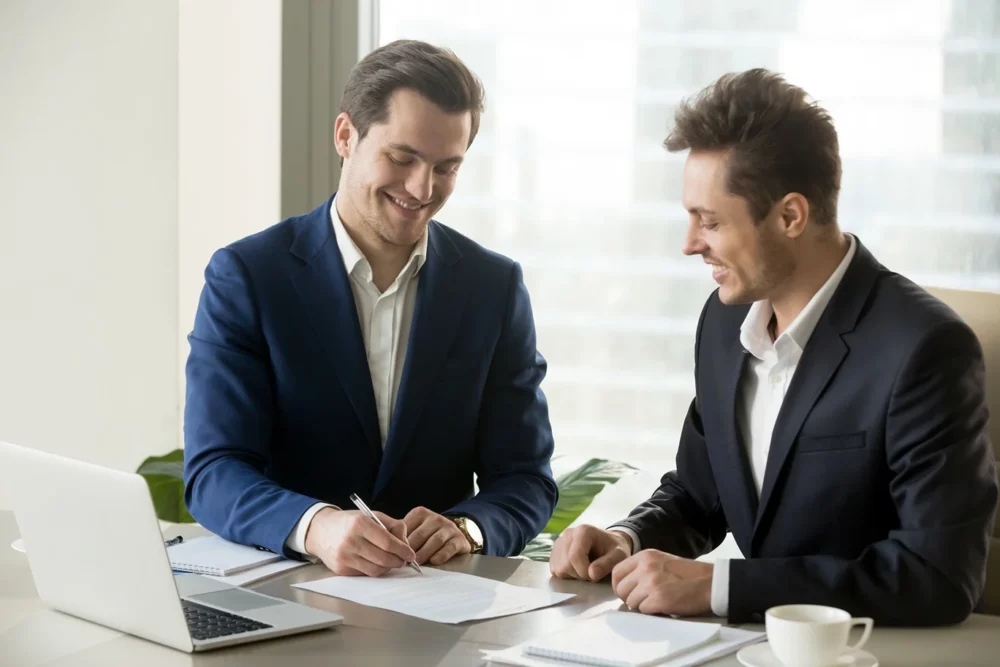 Image of business investors discussing financial strategies, highlighting the role of accounting standards in decision-making.