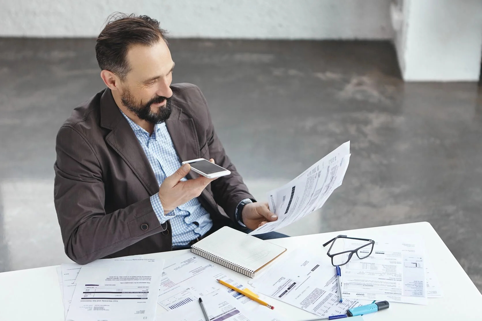 A businessman on the phone, representing consultations related to excise tax health checks in Dubai, UAE.