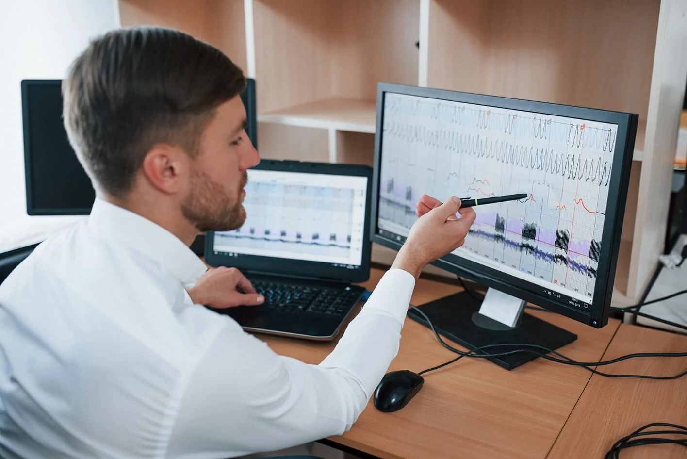 Polygraph examiner in an office, representing the analytical capabilities of ERP software in business processes.