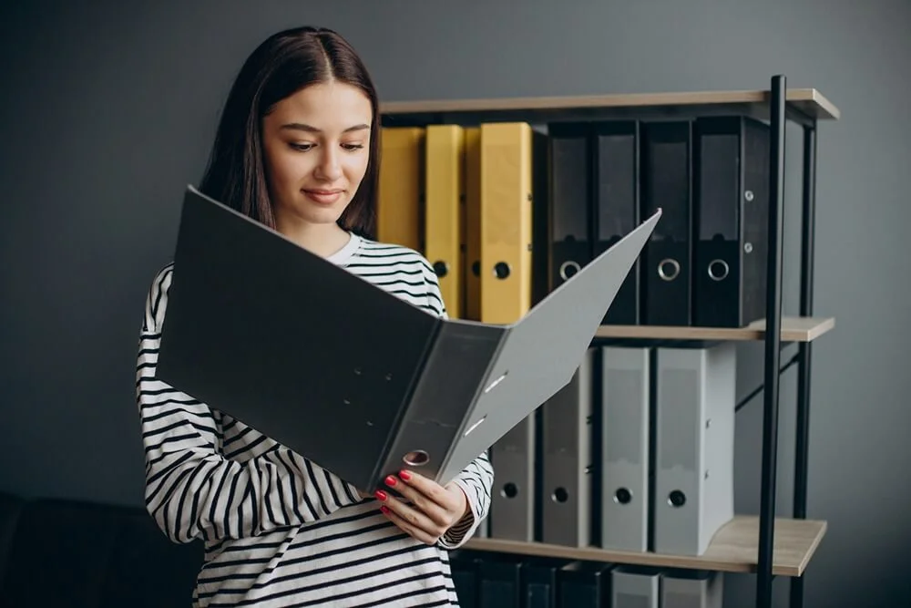 young-woman-working-with-documents-checking-archives